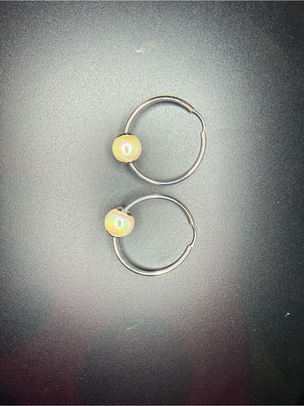 Silver hoop earrings with pearl accent